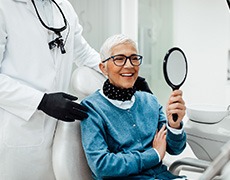 Senior woman smiling while looking at reflection