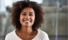 woman smiling with dental crowns in Framingham