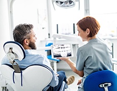 Dentist and patient discussing cost of dental implants in Framingham