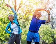 couple wearing exercise clothing and stretching outside 