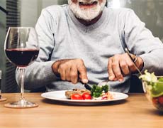 Man with dental implants in Framingham eating a balanced meal