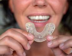 Woman holding a custom mouthguard