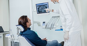 Man and dentist looking at x-rays