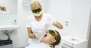Woman receiving laser gum therapy