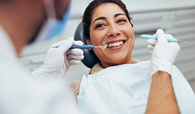Woman smiling at dentist during checkup