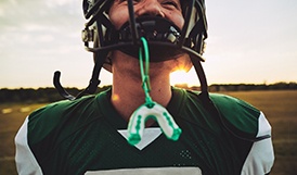 Closeup of mouthguard hanging from football helmet