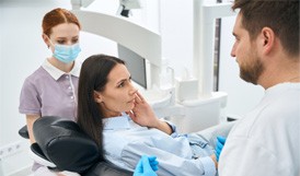 Dentist explaining treatment options to patient with toothache