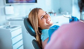 Woman smiling at dentist after dental appointment