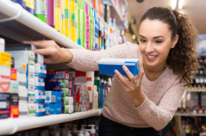 Woman choosing toothpaste 