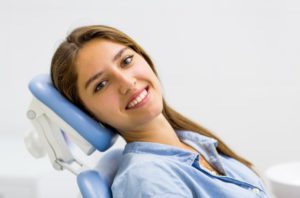 Happy female patient using her dental savings plan