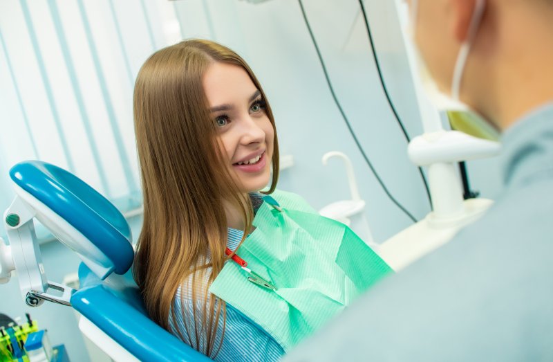 Woman smiling at the dentist after root canals